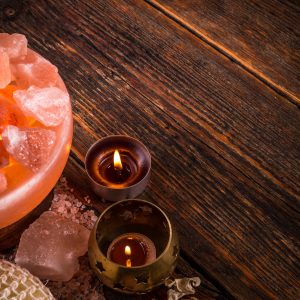 Alternative medicine concept with salt lamp and aromatherapy candle